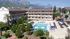 A hotel with a swimming pool, outdoor seating, and mountain views. - Ares Dream Hotel- All Inclusive (Kemer)