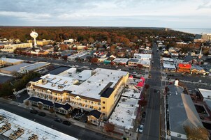 An aerial view of a town with a prominent building featuring a large, white, spherical structure on top.