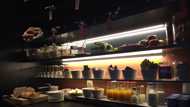 A well-lit kitchen area with shelves stocked with various food items, including fruits, vegetables, and condiments. - B&B Zakske 13 (Bruges)