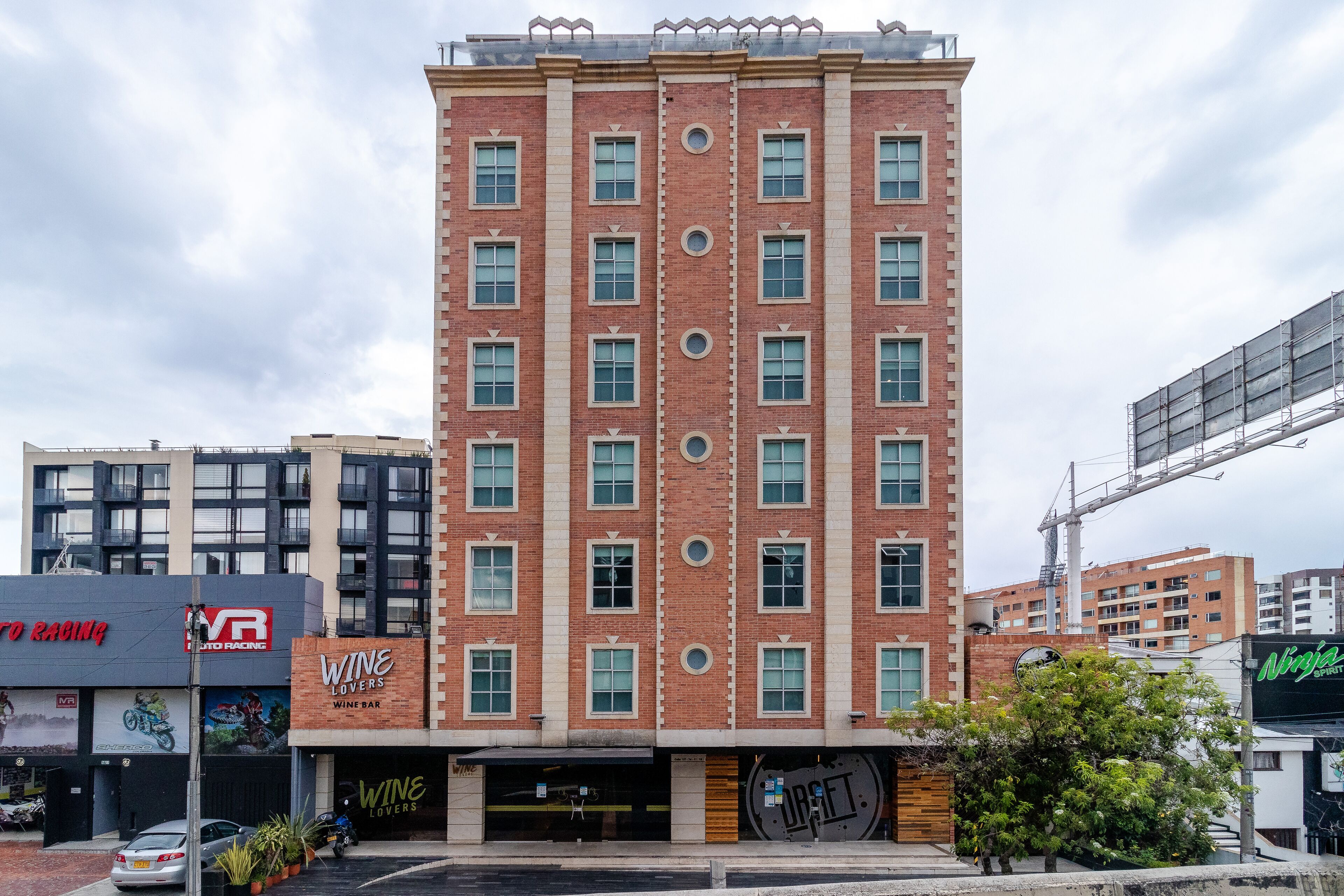 A multi-story brick building with a wine bar at the ground level.