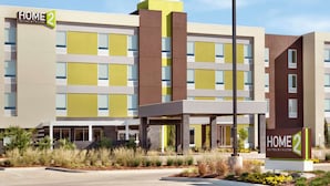 A modern hotel with a sign reading "HOME 2 Suites by Hilton." - Home2 Suites by Hilton West Monroe (West Monroe)