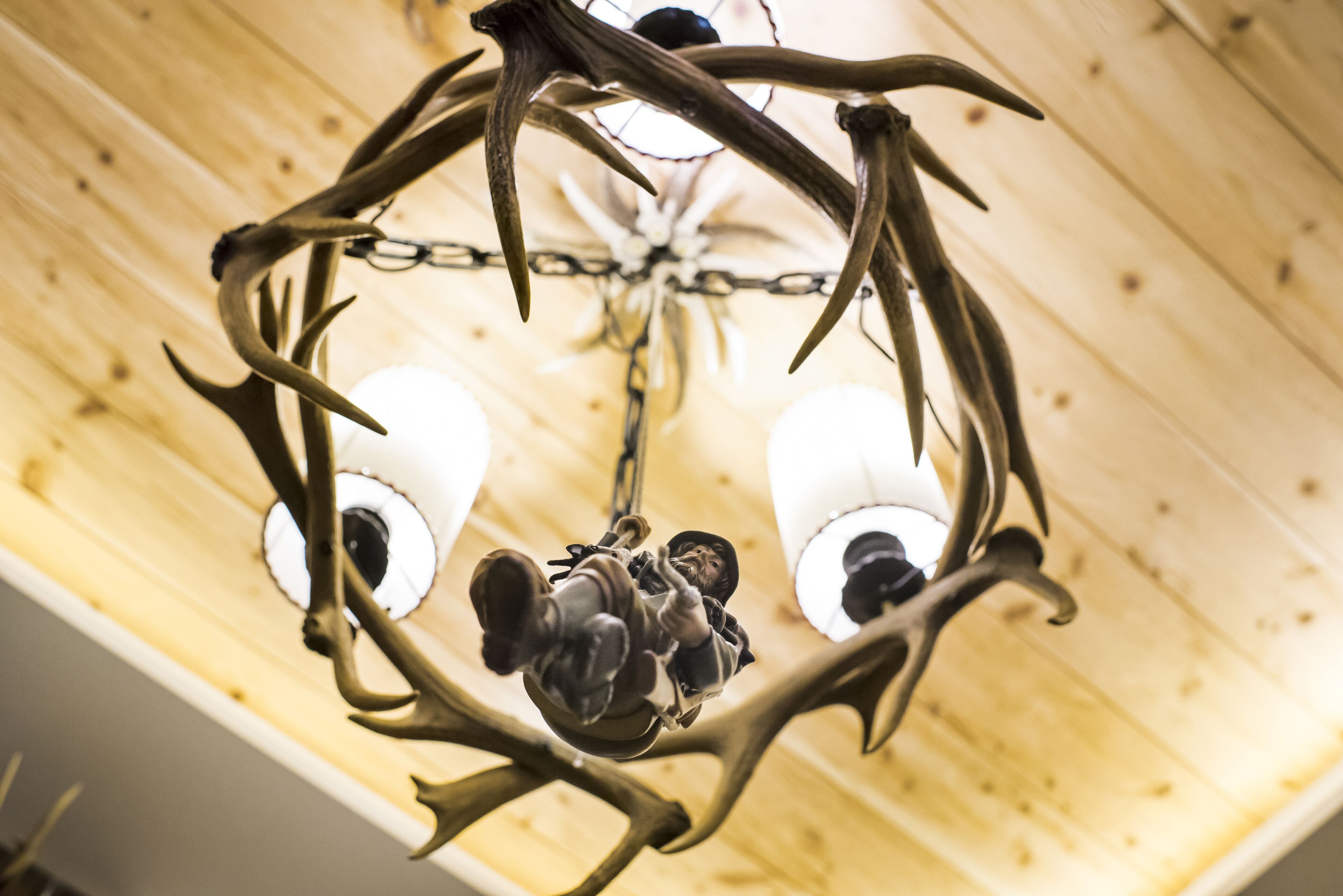 A chandelier with antler designs and two bulbs.