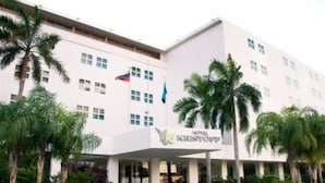 A hotel with a modern facade, multiple windows, and a prominent sign. - Kristoff (Maracaibo)