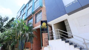A building with a sign for 'Edha Suites' and a staircase leading to an entrance. - Edha Suites (Bengaluru)