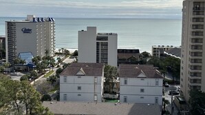 A coastal hotel with multiple buildings, including a prominent hotel named "Carolina Winds" with a view of the ocean. - Ocean Villas Beach Resort (Myrtle Beach)