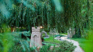 A model train set with a brick tower and a winding track surrounded by greenery. - Rainbow 1 Holiday Complex (Sunny Beach)