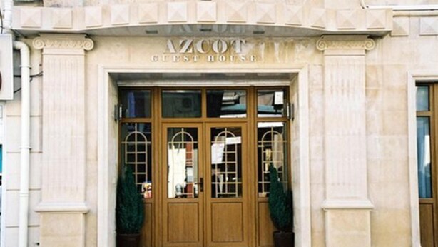 A building with a sign reading "AZCOT GUEST HOUSE". - Azcot (Baku)