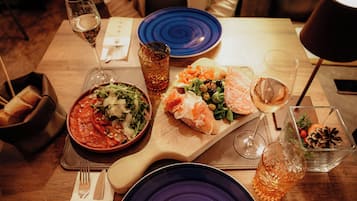 A dining table with a variety of dishes, glasses, and cutlery.