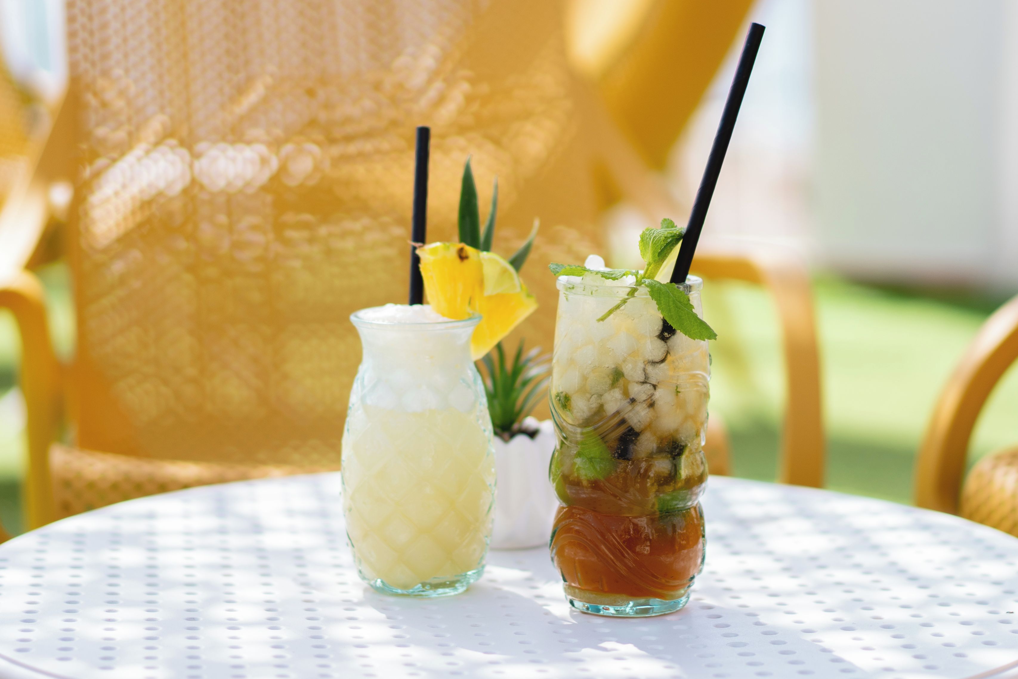 Two drinks on a white table with a textured surface.