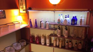A reception area with shelves displaying various toiletries and a 'Welcome' sign. - Que Sera Sera - Adults Only (Neyagawa)