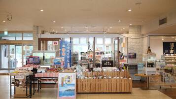 A spacious indoor market with various stalls and displays.