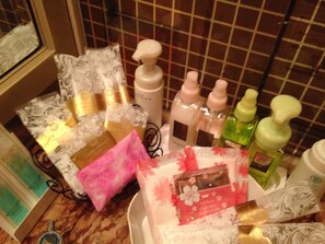 A variety of toiletries and personal care items on a bathroom counter.