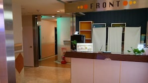 A reception desk with a sign reading "FRONT" and a doormat labeled "DRESSY". - HOTEL DRESSY -Adults Only (Himeji)