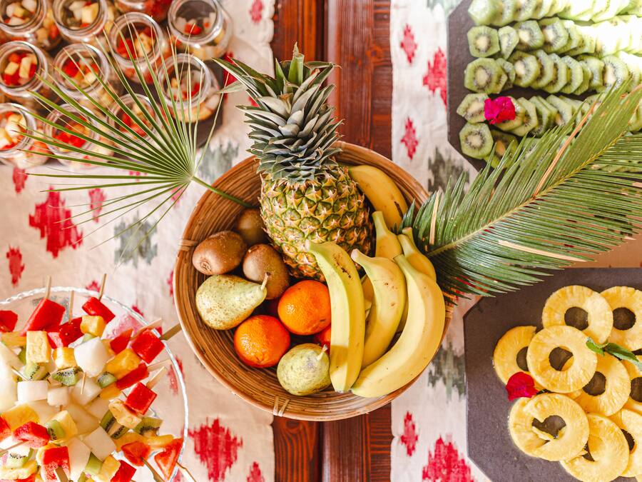 A fruit platter with pineapple, bananas, kiwi, and oranges.