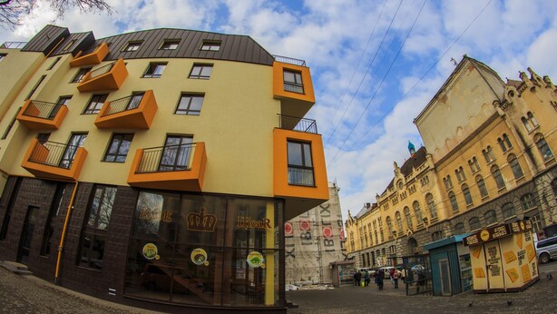 A building with a modern design, featuring balconies and large windows. - Hotel Cisar (Lviv)