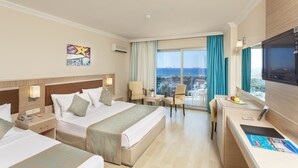 A hotel room with two beds, a desk, a TV, and a balcony with a view of the sea. - Narcia Resort Side - All Inclusive (Manavgat)