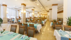 A spacious dining area with multiple tables, chairs, and ambient lighting. - Narcia Resort Side - All Inclusive (Manavgat)