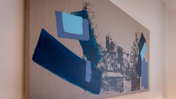 A painting with abstract shapes and a cityscape.
