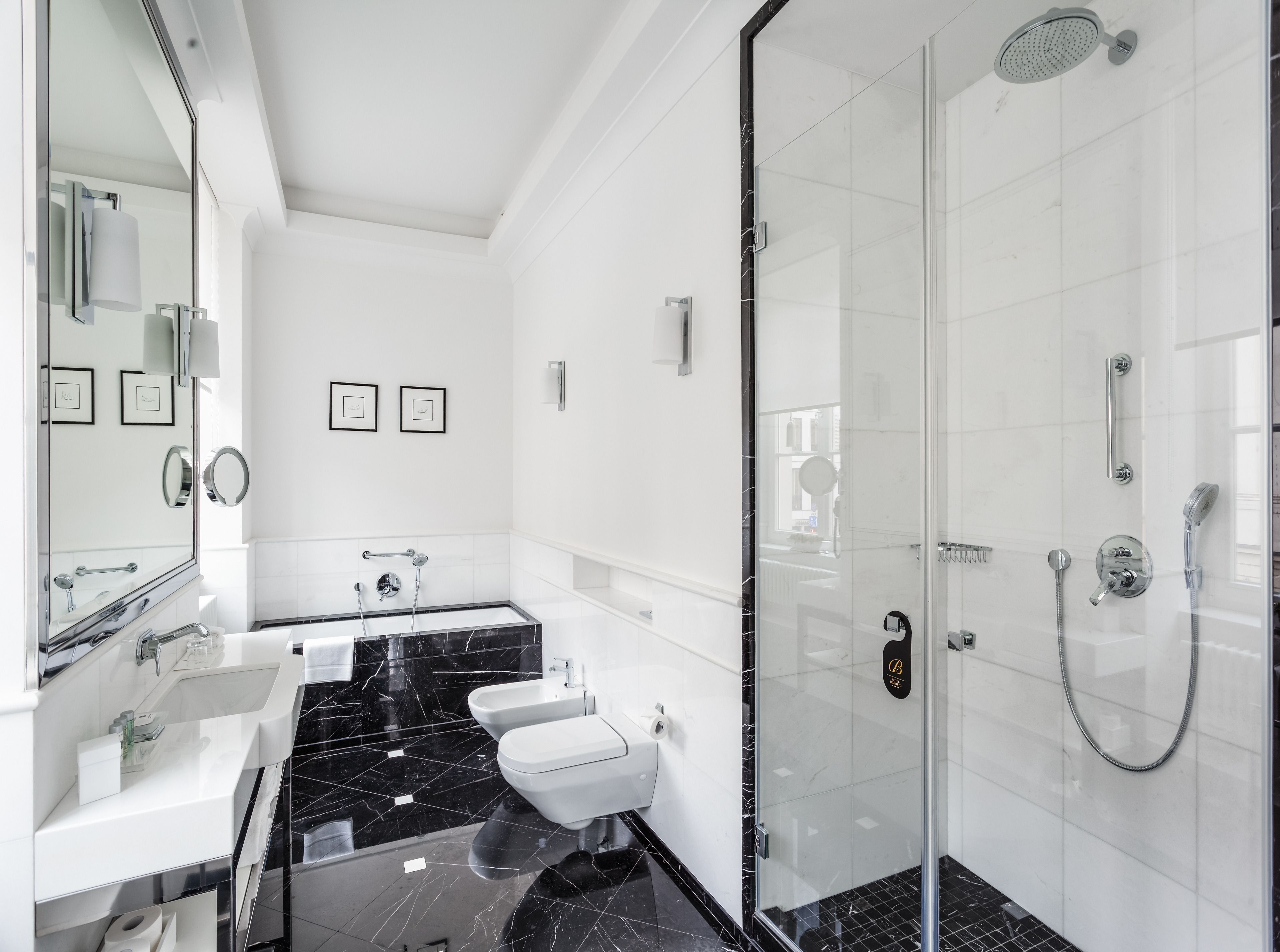 A modern bathroom with a glass shower enclosure, a vanity with a mirror, and a toilet.