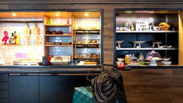 A bakery counter with various baked goods and a sign that reads "PEACE LOVE & MOXY".