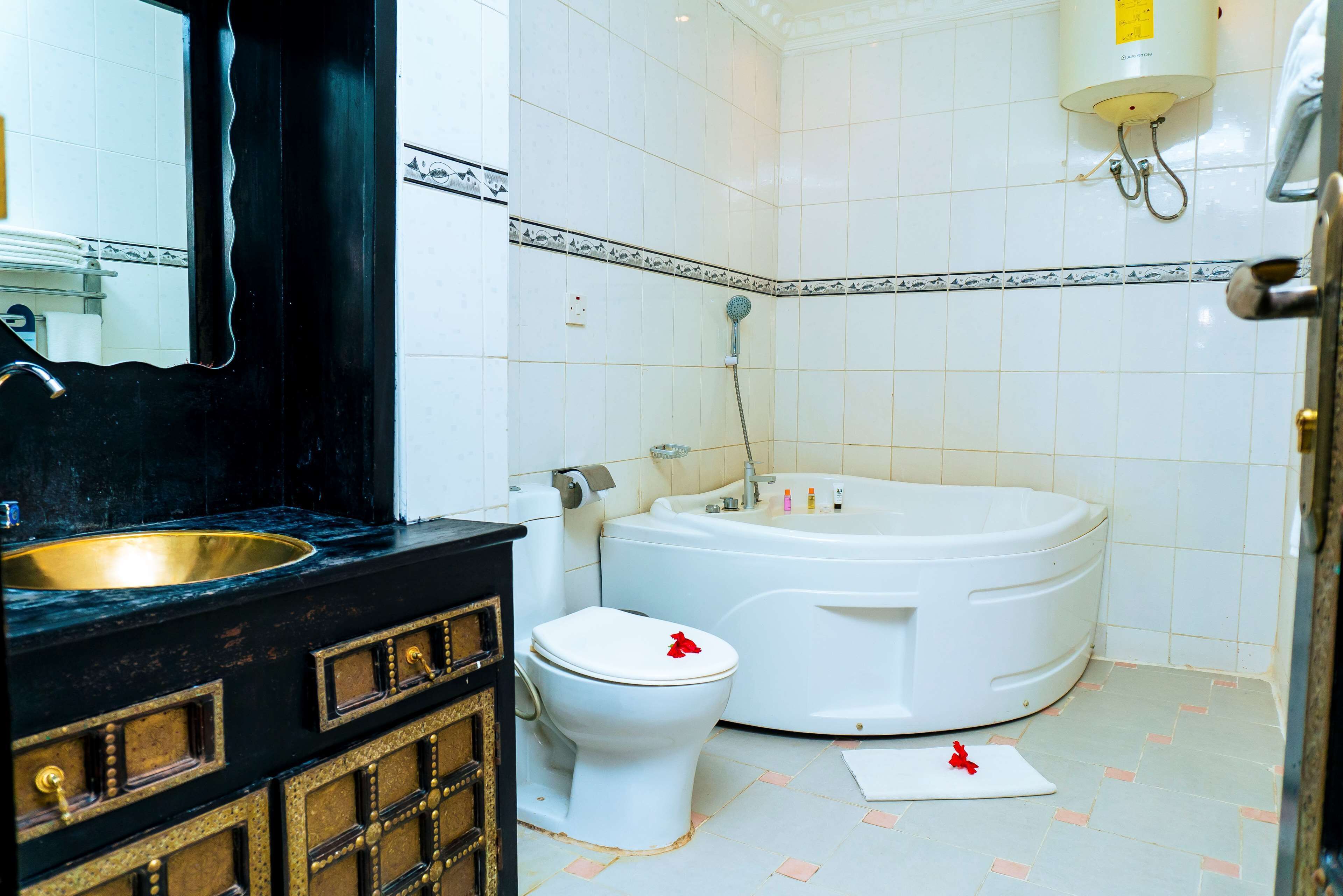 junior suite, 1 king bed | bathroom | eco-friendly toiletries, hair dryer, slippers, towels