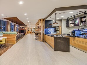 A modern cafe with a wooden counter, seating area, and a visible menu board.