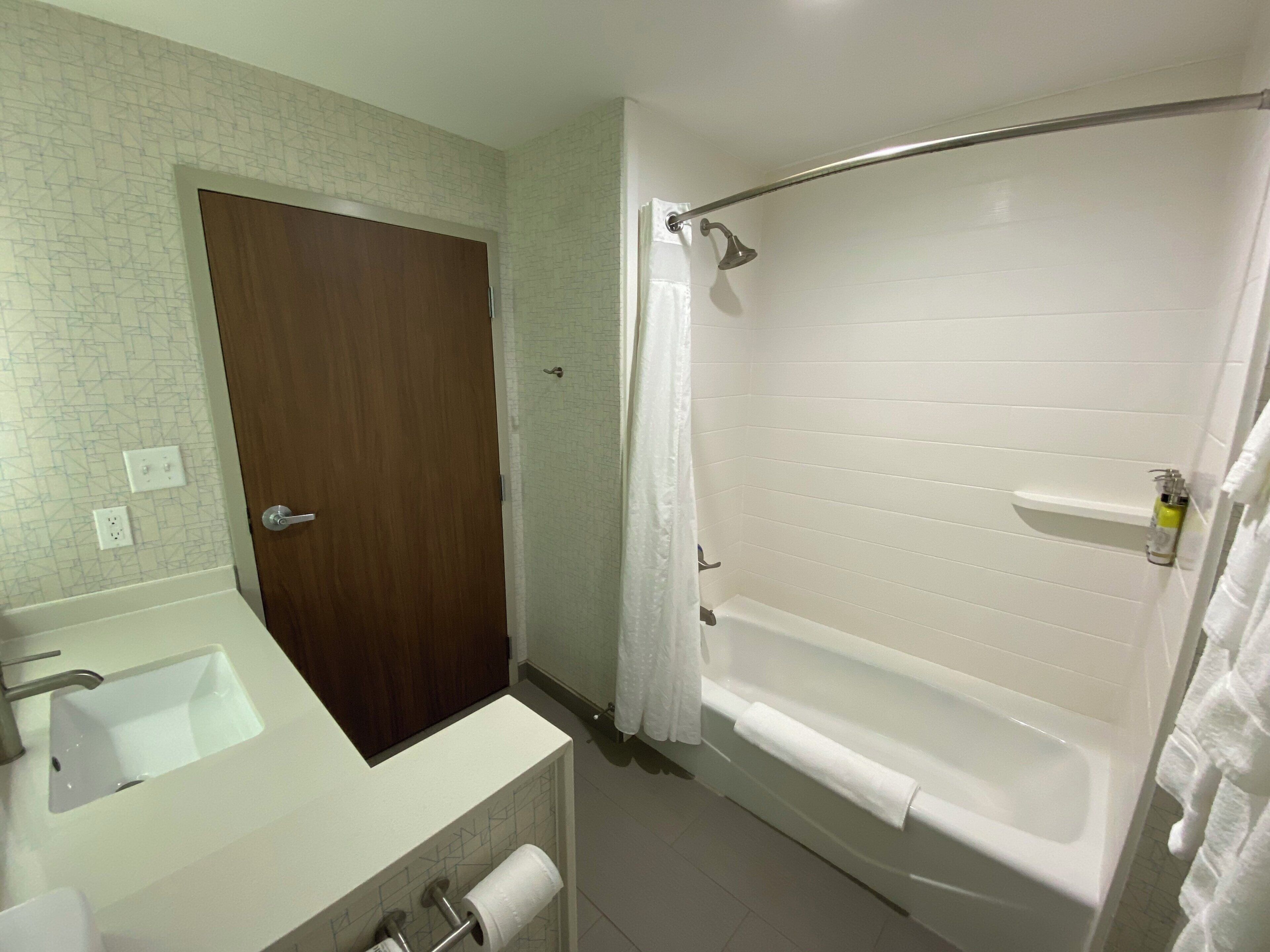 Ein Badezimmer mit Badewanne, Dusche, Waschbecken und Toilette.