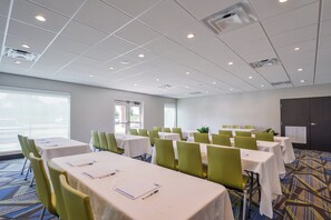 A conference room with tables and chairs, large windows, and a door. - Holiday Inn Express Donaldsonville by IHG (Donaldsonville)