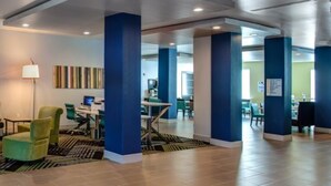 A modern lobby with green chairs, a sofa, and a desk area. - Holiday Inn Express & Suites Gatesville - N. Ft Hood by IHG (Gatesville)
