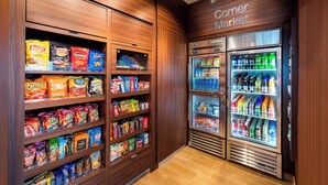 A corner market with shelves stocked with snacks and beverages. - Fairfield Inn & Suites by Marriott Dallas Waxahachie (Waxahachie)