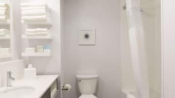 A bathroom with a toilet, sink, and shower curtain.