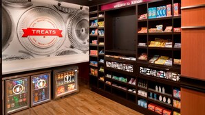 A store interior with shelves stocked with snacks and drinks, a 'Welcome to Kaban' sign, and a 'Treats' sign above a display of ice cream. - Hampton Inn Kanab (Kanab)
