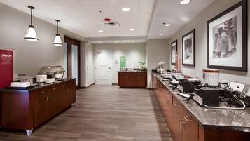 A modern kitchen with wooden cabinets, granite countertops, and stainless steel appliances.
