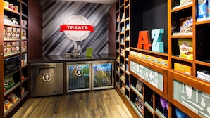 A snack display area with shelves stocked with various snacks and a refrigerated section.