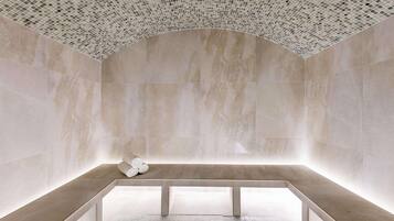 Experience a serene bathroom retreat with a recessed bench, decorative ceiling, and stylish tile flooring.