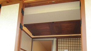 A traditional Japanese room with tatami flooring, sliding doors, and a shoji screen. - Sungsim (Jeonju)