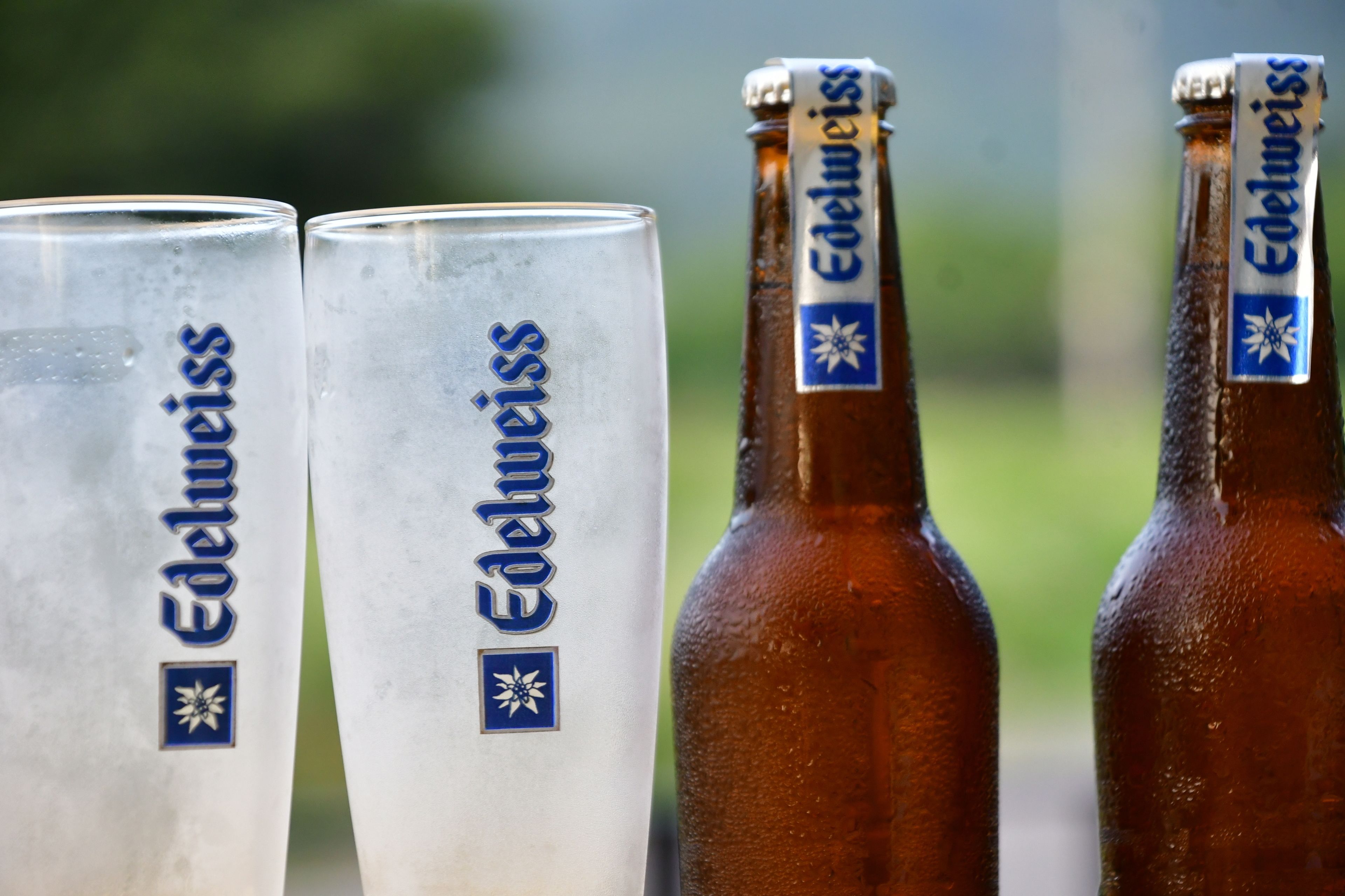 Two beer glasses and two bottles with the brand name 'Edelweiss' visible.