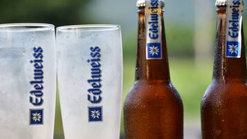 Two beer glasses and two bottles with the brand name 'Edelweiss' visible.