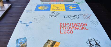 A table with various stickers and drawings, including a map, a sun, and a character illustration.