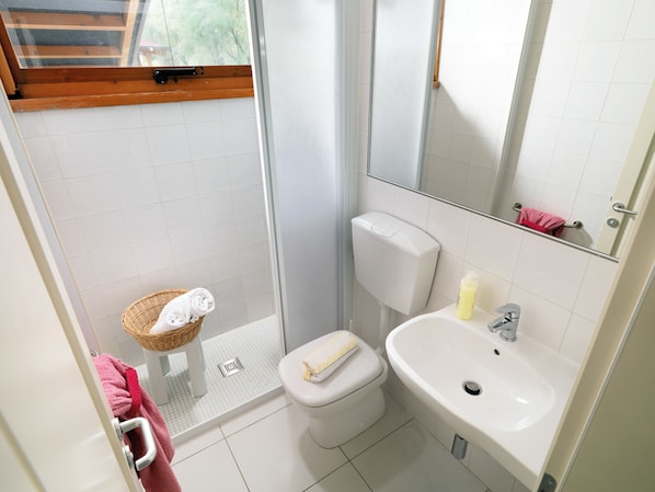 A small bathroom with a shower, toilet, and sink. - Isamar Holiday Village (Chioggia)