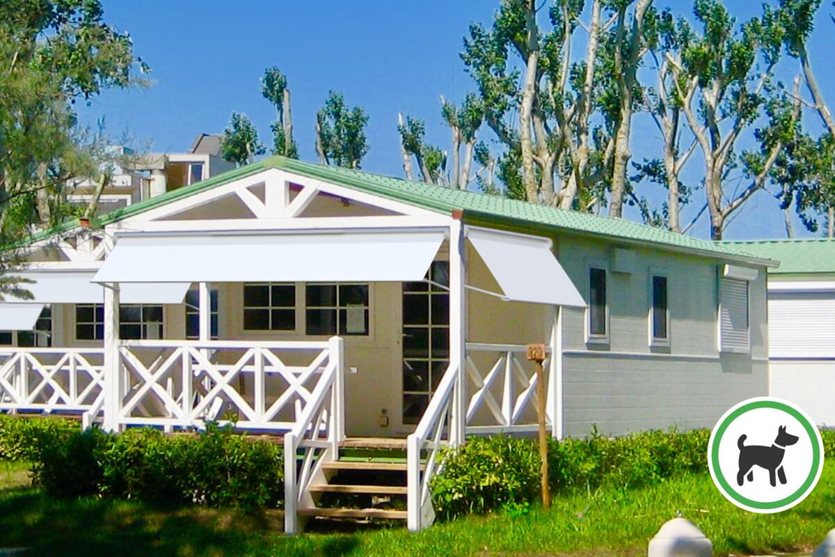 A single-story building with a covered porch and a small staircase leading to the entrance.