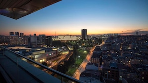 A cityscape at dusk with modern buildings, a prominent high-rise, and a busy road below. - Wish More Hotel Istanbul (Istanbul)