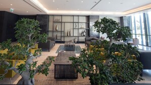 A modern lobby with seating areas, a reception desk, and a display of decorative items. - Wish More Hotel Istanbul (Istanbul)