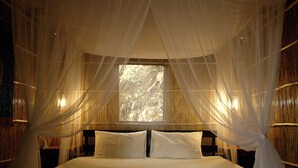 A bed with a canopy, wooden headboard, and two bedside tables. - Gala-Gala Eco Resort (Ponta d'Ouro)