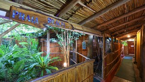 A wooden sign reading "Pirata Beach" in a rustic setting with bamboo structures and lush greenery. - Gala-Gala Eco Resort (Ponta d'Ouro)
