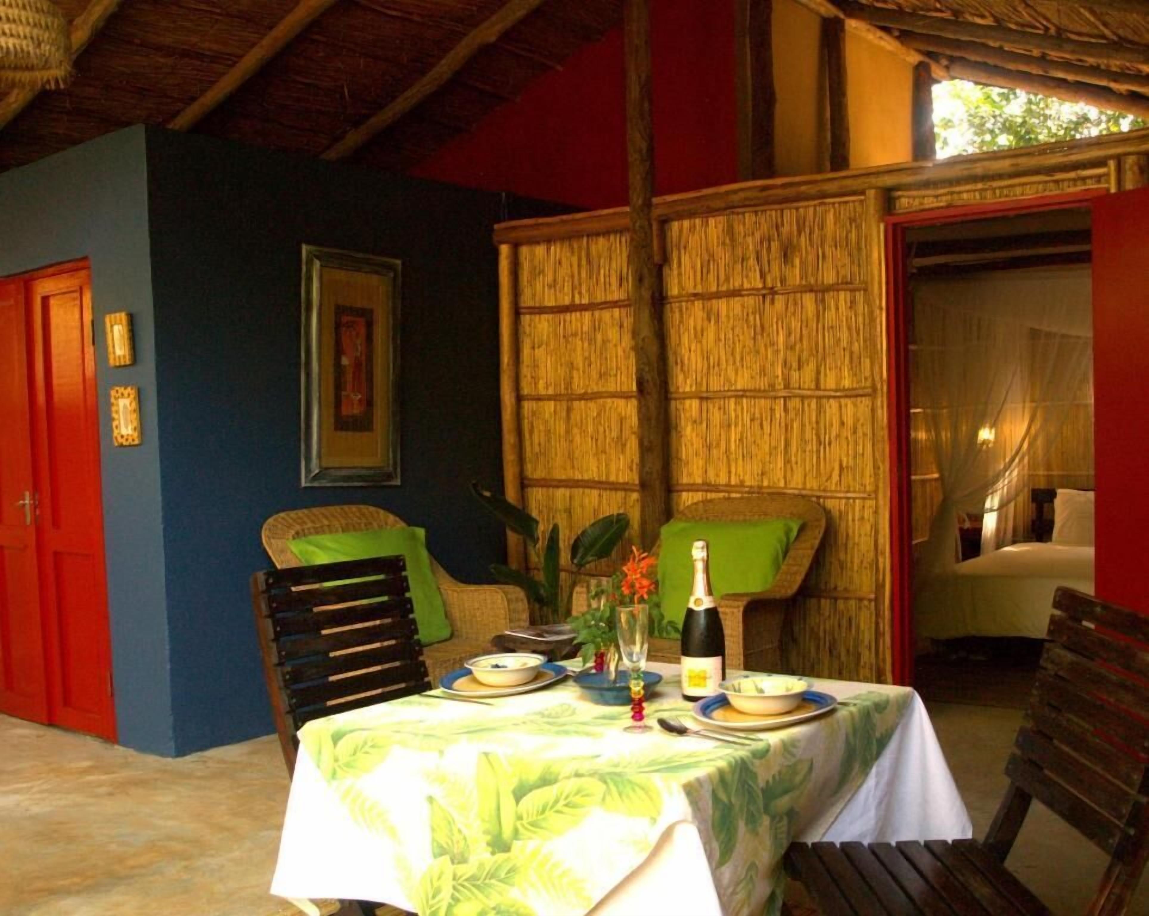 Comedor con una mesa dispuesta para dos, con mantel de temática tropical.