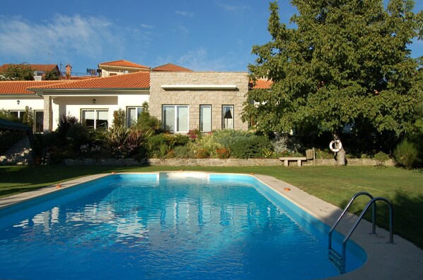 Seasonal outdoor pool, pool umbrellas, pool loungers