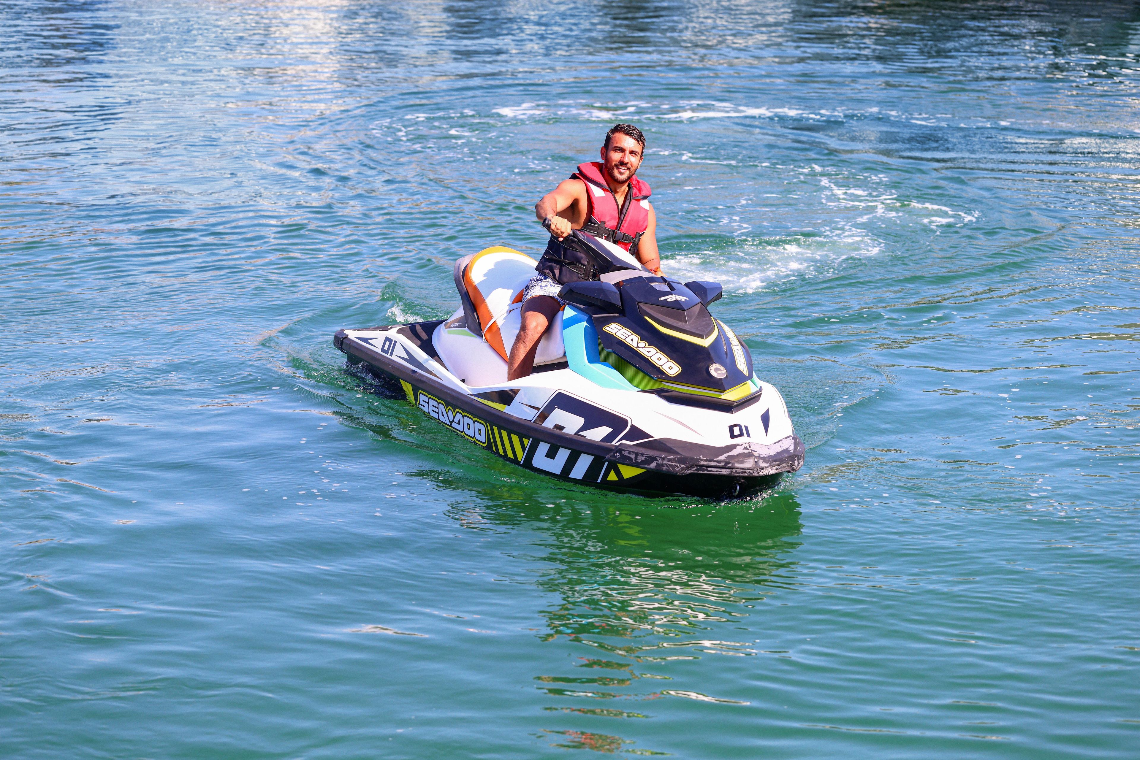A person riding a Sea-Doo jet ski on a body of water.