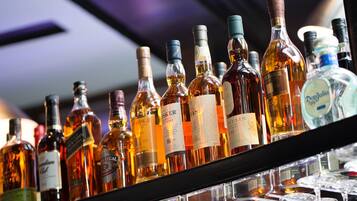 A variety of liquor bottles on a shelf.
