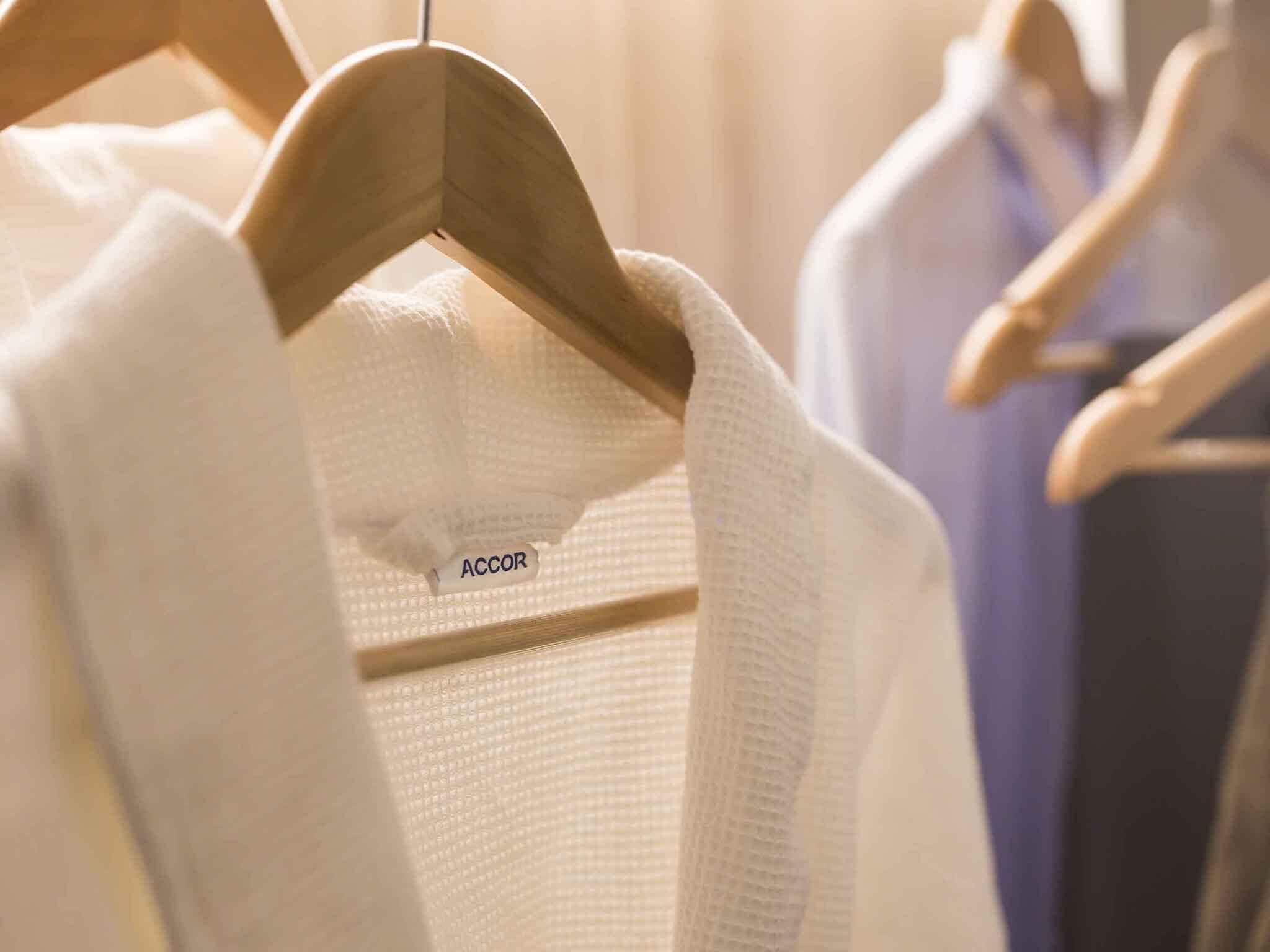A clothing rack with hangers and a tag labeled 'ACCOR'.